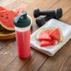 watermelon-preworkout-drink H24 Prepare pre-workout drink in a clear glass filled with vibrant watermelon-colored liquid